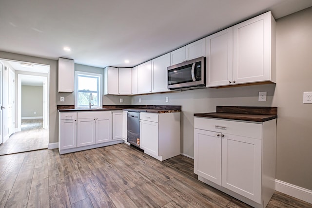 58 Pequawket Trl, Baldwin, ME 04024 - kitchen with appliances with stainless steel finishes, dark countertops, light wood-style floors, white cabinets, and recessed lighting
