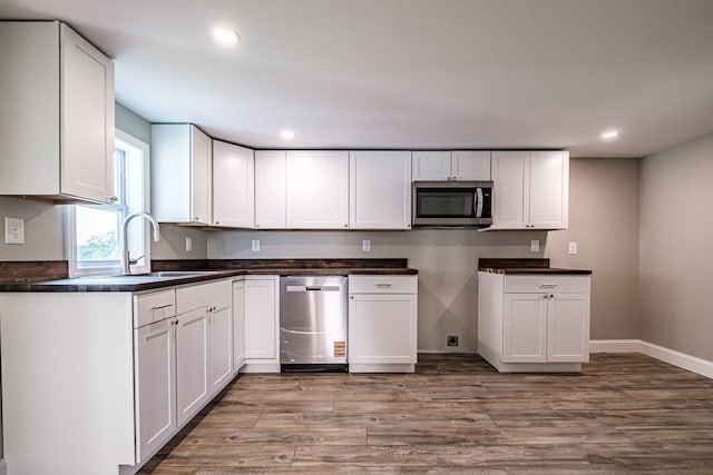 58 Pequawket Trl, Baldwin, ME 04024 - kitchen featuring appliances with stainless steel finishes, light wood-type flooring, dark countertops, recessed lighting, and white cabinets