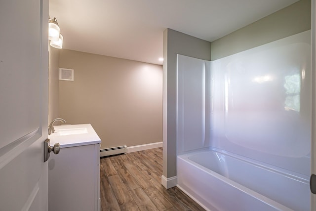 58 Pequawket Trl, Baldwin, ME 04024 - full bathroom with a baseboard heating unit, vanity, wood finished floors, and  shower combination