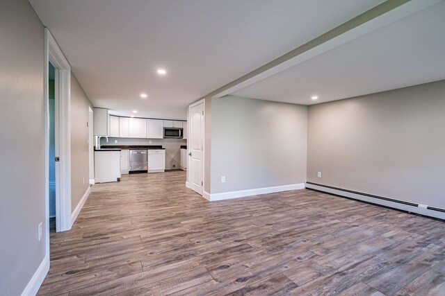 58 Pequawket Trl, Baldwin, ME 04024 - unfurnished living room with wood finished floors and recessed lighting