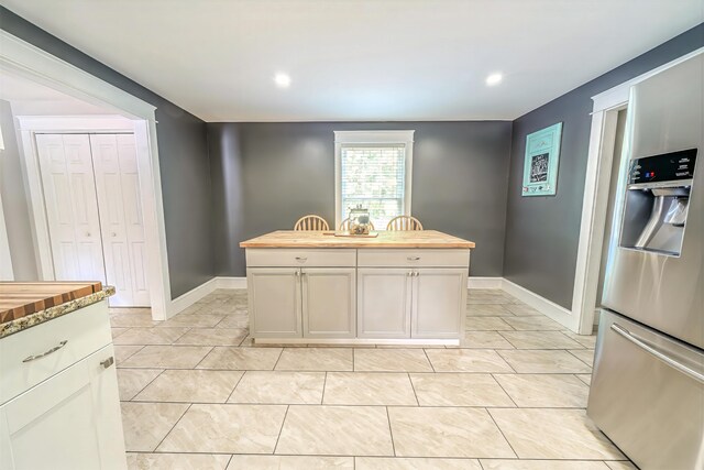 304 Main Rd N, Hampden, ME 04444 - kitchen featuring wooden counters, stainless steel fridge with ice dispenser, a kitchen island, baseboards, and recessed lighting
