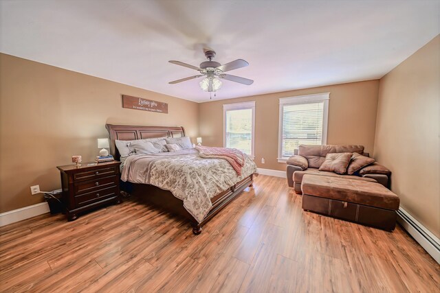 304 Main Rd N, Hampden, ME 04444 - bedroom with a baseboard radiator, light wood finished floors, baseboards, and ceiling fan