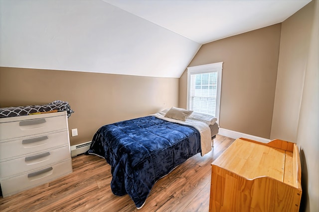 304 Main Rd N, Hampden, ME 04444 - bedroom featuring baseboard heating, vaulted ceiling, and wood finished floors