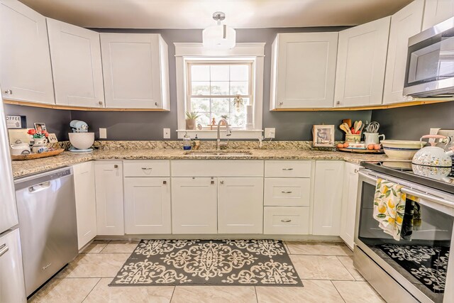 304 Main Rd N, Hampden, ME 04444 - kitchen featuring appliances with stainless steel finishes, a sink, white cabinets, and light stone counters