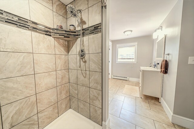 304 Main Rd N, Hampden, ME 04444 - full bathroom with a baseboard radiator, tiled shower, vanity, and baseboards
