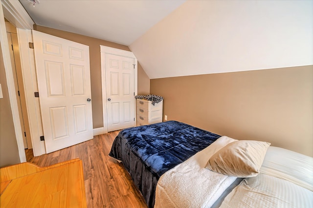 304 Main Rd N, Hampden, ME 04444 - bedroom featuring wood finished floors and lofted ceiling