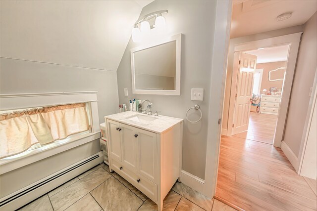 304 Main Rd N, Hampden, ME 04444 - bathroom featuring baseboard heating, vanity, baseboards, and lofted ceiling