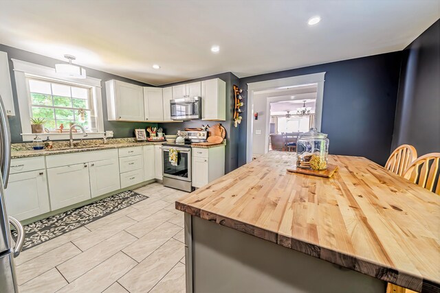 304 Main Rd N, Hampden, ME 04444 - kitchen featuring appliances with stainless steel finishes, a sink, wood counters, a chandelier, and recessed lighting
