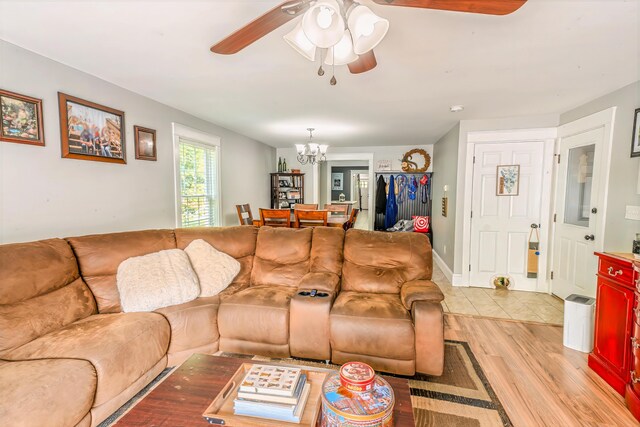304 Main Rd N, Hampden, ME 04444 - living area featuring ceiling fan, light wood finished floors, and a chandelier