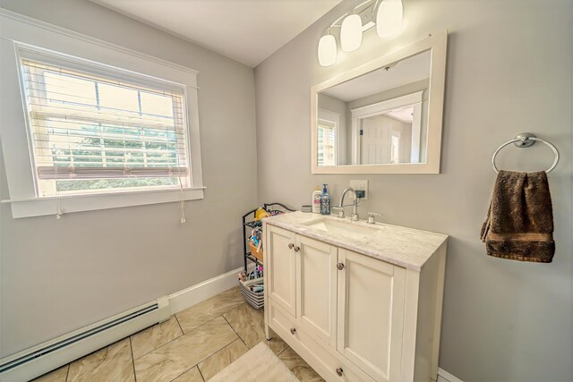 304 Main Rd N, Hampden, ME 04444 - bathroom with baseboard heating, healthy amount of natural light, vanity, and marble finish floors