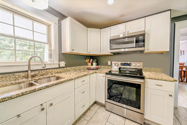 304 Main Rd N, Hampden, ME 04444 - kitchen featuring stainless steel appliances, a sink, light tile patterned flooring, and white cabinetry