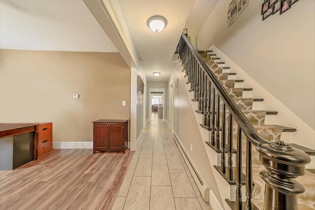 304 Main Rd N, Hampden, ME 04444 - corridor featuring a baseboard heating unit, stairs, and baseboards
