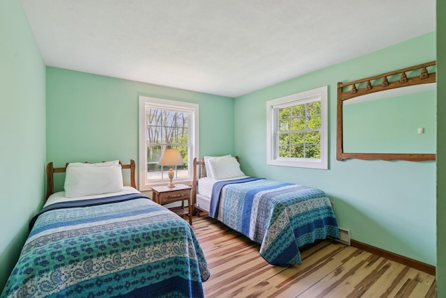 16 Marsh View Ave, Kennebunk, ME 04043 - bedroom with multiple windows, wood finished floors, and baseboards