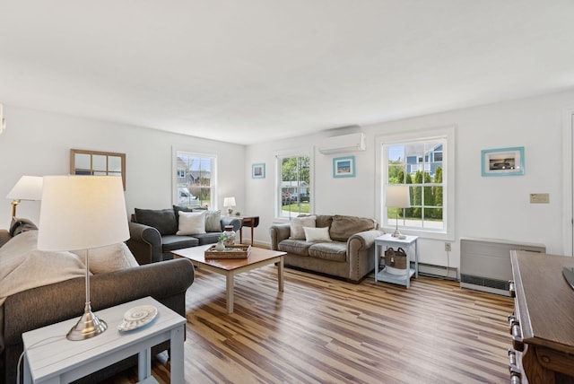 16 Marsh View Ave, Kennebunk, ME 04043 - living room with a wall unit AC, a baseboard heating unit, light wood-type flooring, and baseboards