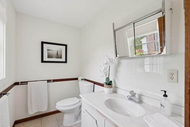 16 Marsh View Ave, Kennebunk, ME 04043 - bathroom with radiator heating unit, vanity, toilet, baseboards, and tile patterned floors