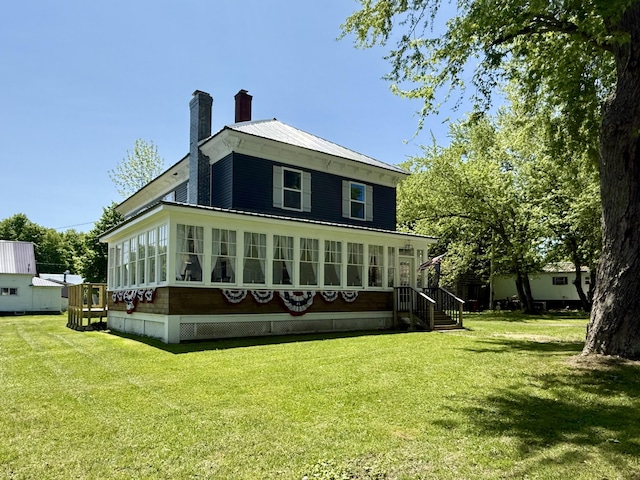 88 Union St, Calais, ME 04619 - back of property with a chimney, a lawn, and metal roof