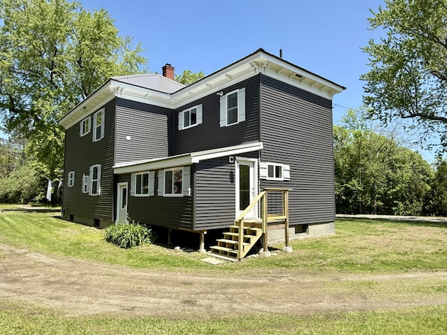 88 Union St, Calais, ME 04619 - rear view of house featuring a chimney and a lawn