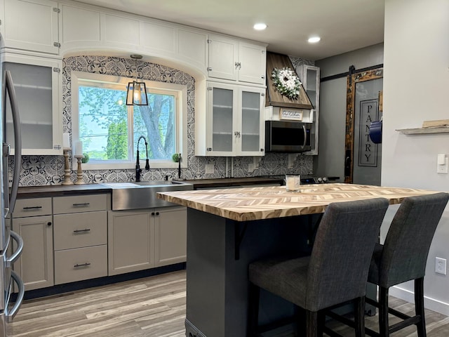 88 Union St, Calais, ME 04619 - kitchen featuring butcher block counters, a sink, backsplash, appliances with stainless steel finishes, and recessed lighting