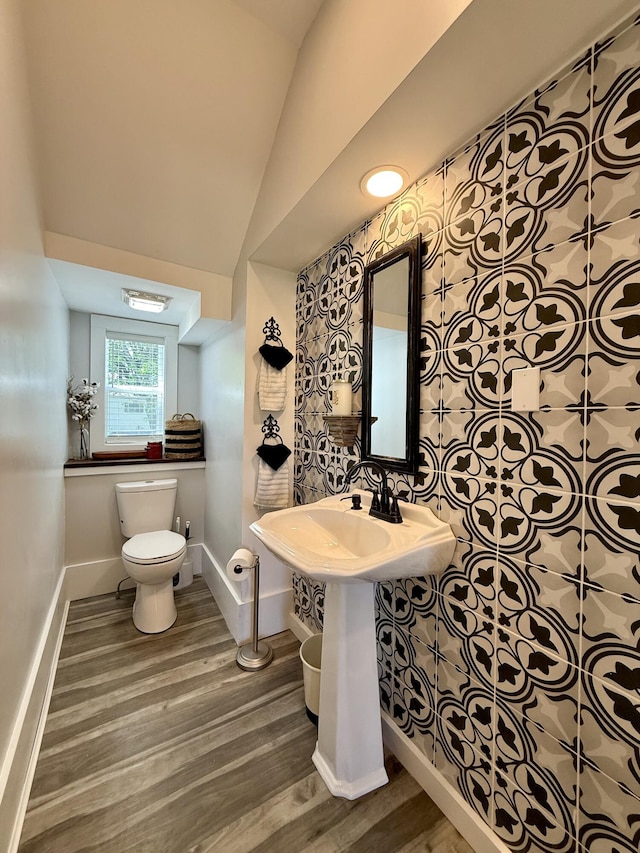88 Union St, Calais, ME 04619 - bathroom featuring toilet, wood finished floors, baseboards, and vaulted ceiling