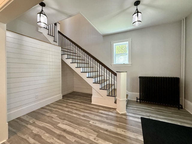 88 Union St, Calais, ME 04619 - staircase with radiator, wood finished floors, and baseboards