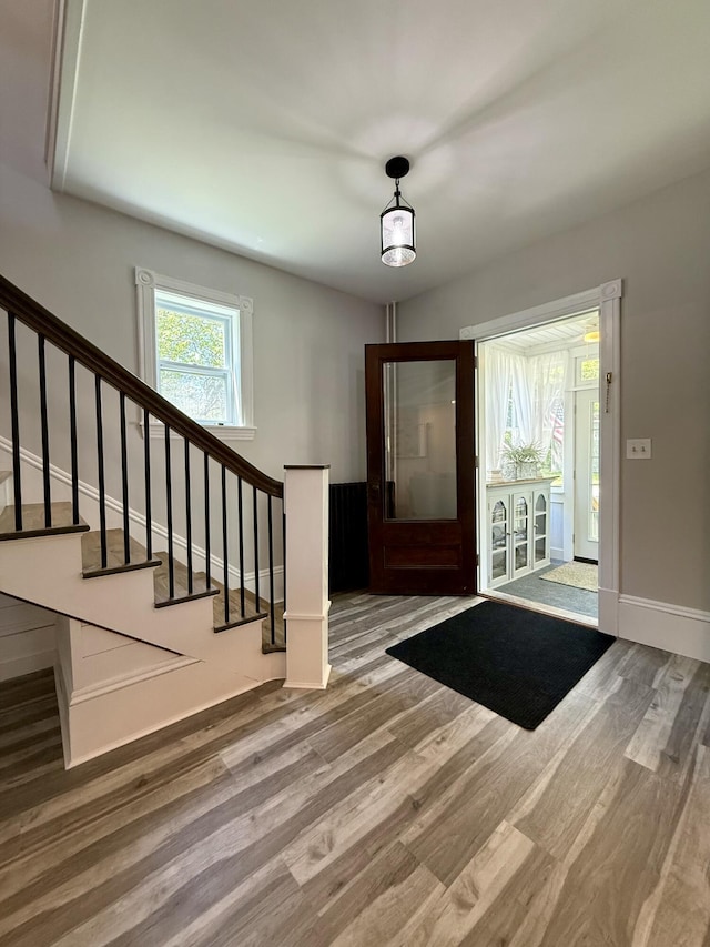 88 Union St, Calais, ME 04619 - foyer entrance featuring wood finished floors, stairs, and baseboards