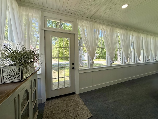 88 Union St, Calais, ME 04619 - entryway with dark colored carpet, wood ceiling, and baseboards