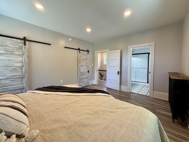 88 Union St, Calais, ME 04619 - bedroom featuring a barn door, baseboards, dark wood-style flooring, ensuite bath, and recessed lighting