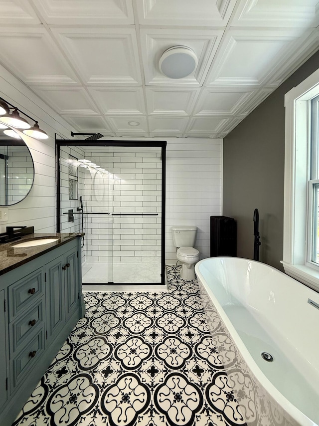 88 Union St, Calais, ME 04619 - bathroom with vanity, a freestanding bath, toilet, a stall shower, and wooden walls