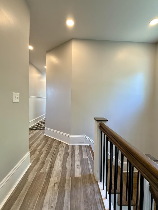 88 Union St, Calais, ME 04619 - corridor with baseboards, wood finished floors, an upstairs landing, and recessed lighting