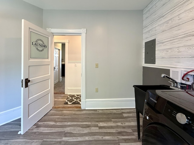 88 Union St, Calais, ME 04619 - office space featuring electric panel, washer / clothes dryer, wooden walls, wood finished floors, and baseboards