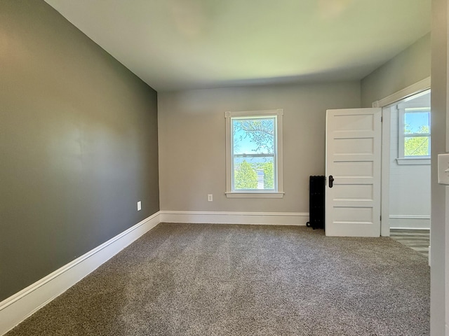 88 Union St, Calais, ME 04619 - unfurnished room with dark colored carpet and baseboards