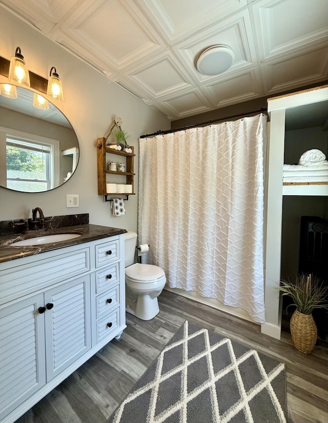 88 Union St, Calais, ME 04619 - full bathroom featuring vanity, wood finished floors, toilet, and shower / bath combination with curtain