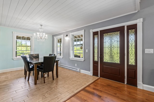 55 Mountain View Ext, Rockland, ME 04841 - dining room featuring baseboard heating, a chandelier, plenty of natural light, wood finished floors, and ornamental molding