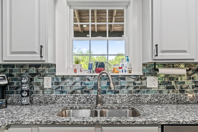 55 Mountain View Ext, Rockland, ME 04841 - kitchen with a sink, backsplash, white cabinetry, and light stone counters