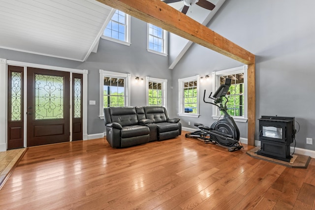 55 Mountain View Ext, Rockland, ME 04841 - living area featuring high vaulted ceiling, hardwood / wood-style floors, a wood stove, baseboards, and ceiling fan