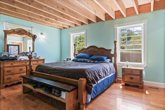 55 Mountain View Ext, Rockland, ME 04841 - bedroom with light wood finished floors, beam ceiling, a baseboard radiator, and baseboards