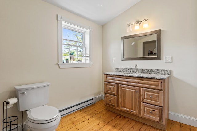 55 Mountain View Ext, Rockland, ME 04841 - half bath with a baseboard radiator, vanity, hardwood / wood-style flooring, toilet, and vaulted ceiling
