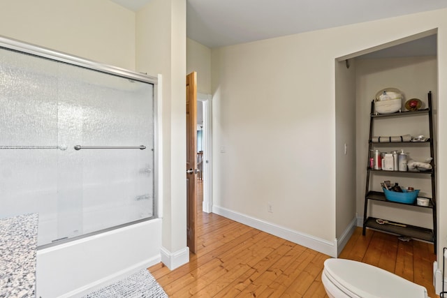 55 Mountain View Ext, Rockland, ME 04841 - bathroom featuring wood-type flooring, combined bath / shower with glass door, toilet, and baseboards
