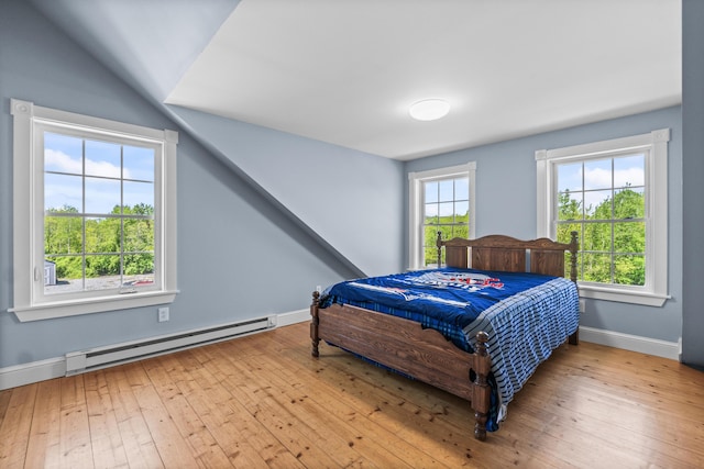 55 Mountain View Ext, Rockland, ME 04841 - bedroom with baseboard heating, multiple windows, wood-type flooring, baseboards, and vaulted ceiling