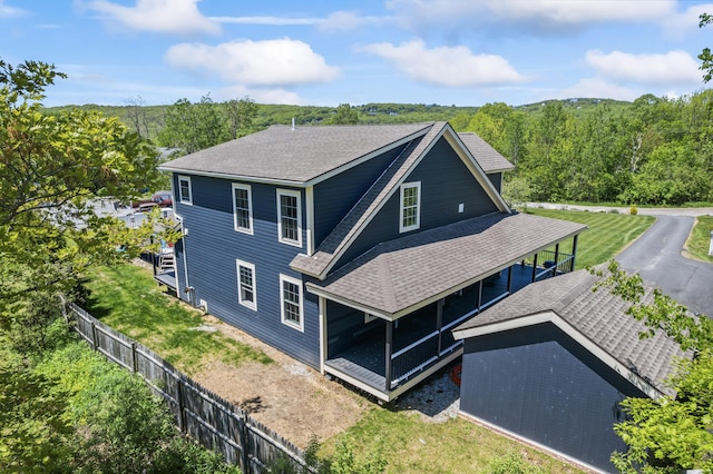 55 Mountain View Ext, Rockland, ME 04841 - rear view of house featuring roof with shingles and a forest view