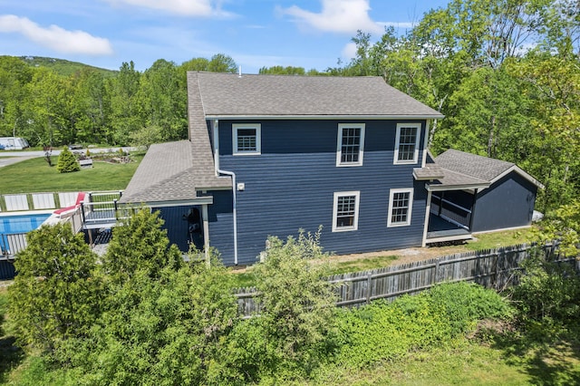 55 Mountain View Ext, Rockland, ME 04841 - view of property exterior featuring roof with shingles, a forest view, and a sunroom
