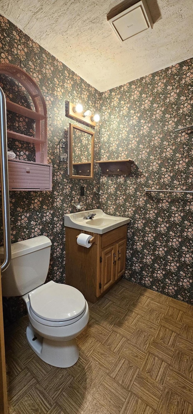 20 Oosoola St, Norridgewock, ME 04957 - half bathroom with vanity, toilet, wallpapered walls, and a textured ceiling