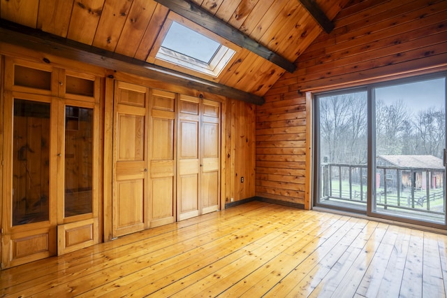 526 Range Rd, Dover-Foxcroft, ME 04426 - unfurnished room featuring a skylight, wood ceiling, light wood-style floors, and wood walls