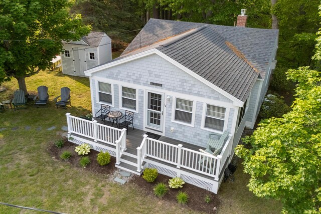 14 Larrys Ldg Unit 14, Ogunquit, ME 03907 - view of front of property with roof with shingles, a chimney, a wooden deck, and a front lawn
