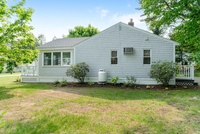 14 Larrys Ldg Unit 14, Ogunquit, ME 03907 - view of home's exterior featuring a chimney, a yard, and a wall mounted air conditioner