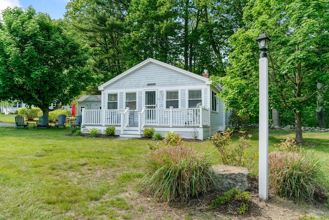 14 Larrys Ldg Unit 14, Ogunquit, ME 03907 - bungalow-style home featuring a front yard, a wooden deck, and a chimney