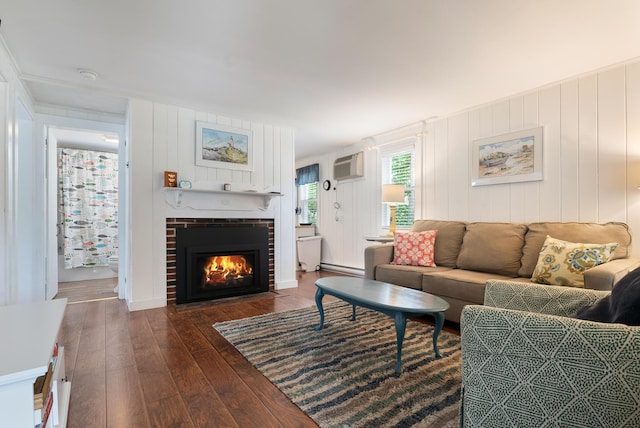 14 Larrys Ldg Unit 14, Ogunquit, ME 03907 - living room with hardwood / wood-style floors, a brick fireplace, a wall mounted air conditioner, and a baseboard radiator