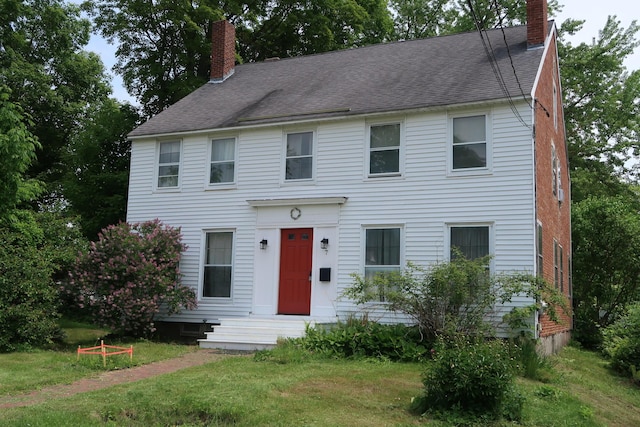 7 Elm St, Augusta, ME 04330 - colonial house featuring a chimney, a shingled roof, a front yard, and entry steps