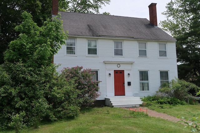 7 Elm St, Augusta, ME 04330 - colonial home with a chimney, a front yard, and roof with shingles