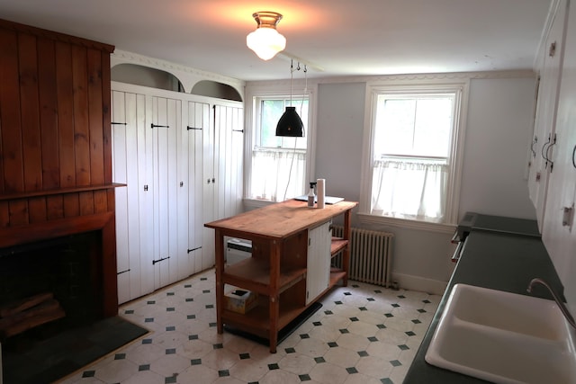 7 Elm St, Augusta, ME 04330 - kitchen with radiator, a sink, plenty of natural light, and light floors